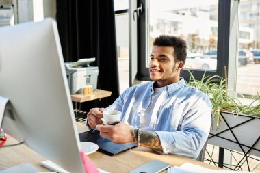 A charming man smiles with coffee at a sleek desk surrounded by lush plants. clipart