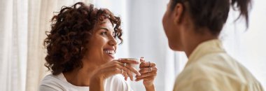 A young African American couple enjoys a cozy breakfast together, sharing smiles and coffee, banner clipart