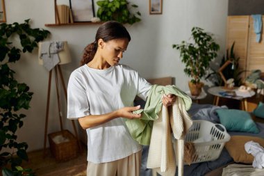 A young African American woman tidies up her apartment, focusing on daily household chores. clipart