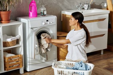 A young African American woman is diligently cleaning in her stylish and tidy apartment. clipart