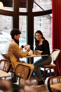 A lovely couple celebrates their love with an intimate dinner on Valentines Day, sharing smiles. clipart