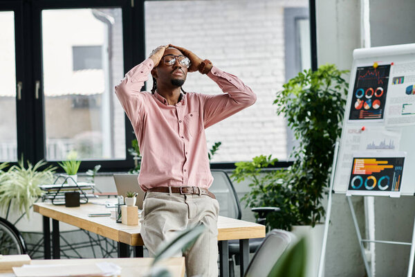 Молодой африканский американец делится своими мыслями в стильном, зеленом офисе.
