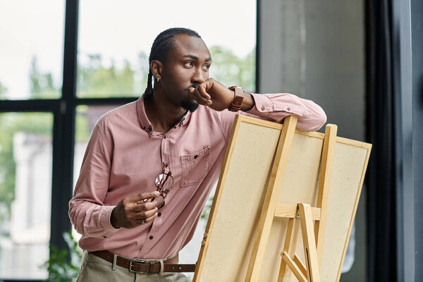 This young african american man is deep in thought as he prepares for his next artistic project.