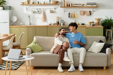 Two men enjoy quality time together on their cozy couch in a stylish apartment.