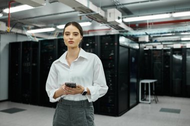 A skilled professional in a white shirt works diligently within a contemporary server room. clipart