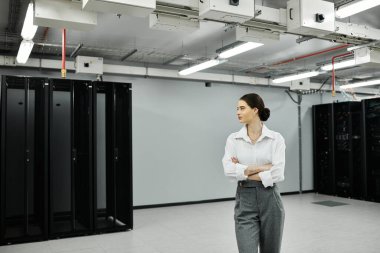 Beyaz gömlekli nitelikli bir bilişim uzmanı sunucu işlemlerini etkin bir şekilde denetliyor.