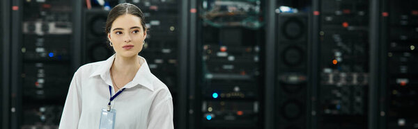 A skilled woman in a white shirt manages server systems in a high-tech data center, banner