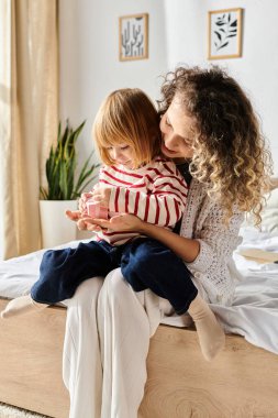 A mother and daughter enjoy quality time together creating and learning in their cozy living space. clipart