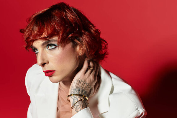 A young man with vibrant red hair poses confidently, showcasing his unique style and charm.