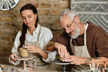 A beautiful couple engages in pottery together, enjoying quality time and creativity with clay. clipart