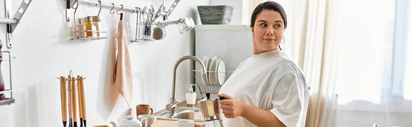 A young plus sized woman enjoys her time preparing a delicious meal in a sunny kitchen.