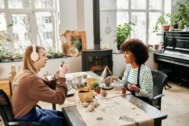 Two friends share joy and creativity at a lively succulent workshop. clipart