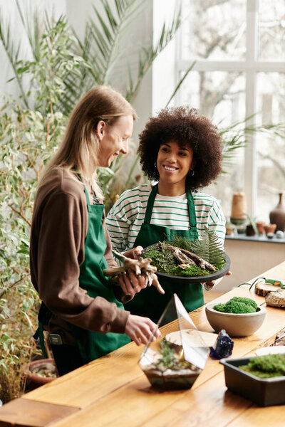 Participants joyfully craft with succulents in a lush green workshop.