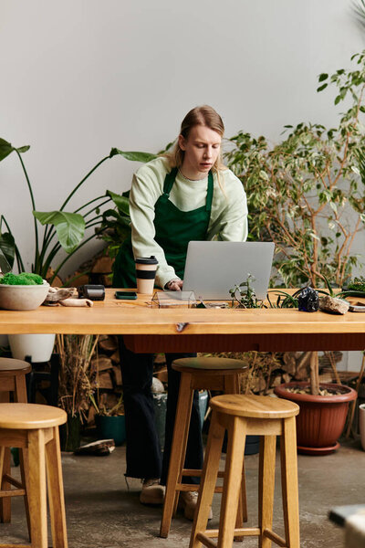 Young man working with his laptop in a vibrant green setting.
