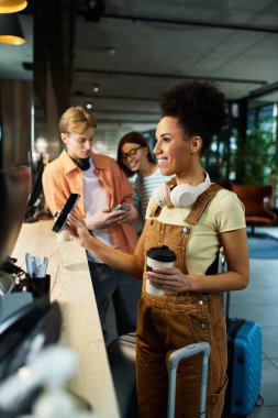 Group of colleagues at the hotel counter sharing a moment while checking in, enjoying their trip. clipart