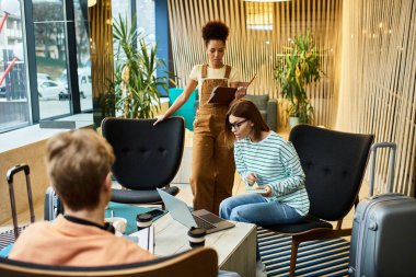 Team members engage in productive discussions while enjoying a hotel lounge atmosphere. clipart