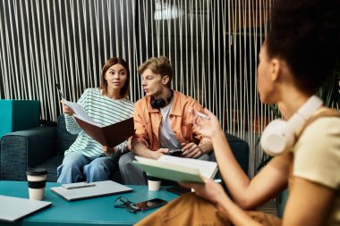 Two colleagues engage in a lively discussion while the third takes notes in a hotel setting. clipart