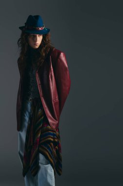 Çarpıcı şapkalı ve desenli kıyafetli şık bir adam cesur moda seçimleri sergiliyor..