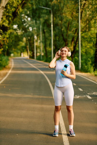 A young woman stretches while jogging on a serene morning trail surrounded by trees.