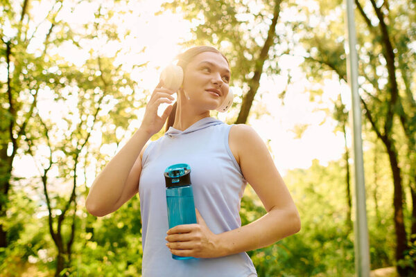 Afternoon sunlight highlights a fit young woman as she enjoys a lovely park.