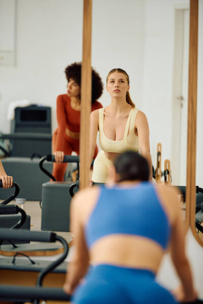 Passionate people demonstrate focus and strength in their engaging pilates class.