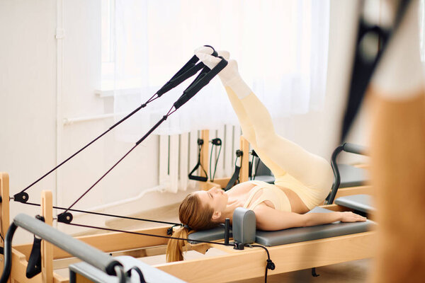 Сосредоточенный человек работает на реформаторе, демонстрируя силу и гибкость.