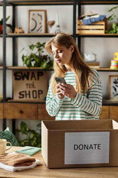 A young woman is sorting her clothes while thoughtfully checking her phone in a warmly lit room.