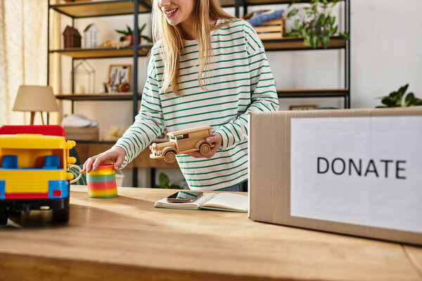 Young woman practices waste sorting, donating toys to promote sustainability.