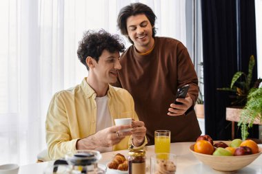 Eşcinsel çift keyifli bir sabah geçirir, içkilerini yudumlar ve güzel bir dairede gülümsemelerini paylaşırlar..