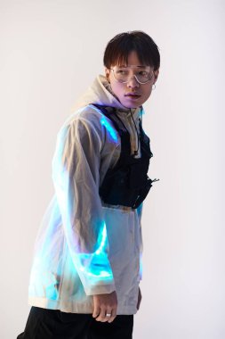 Kendine güvenen genç Asyalı bir adam bir stüdyoda çağdaş moda trendlerini modelliyor..