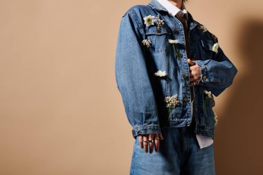 Kırpılmış adam şık bahar kıyafetini güzel tasarlanmış stüdyo ortamında sergiliyor..