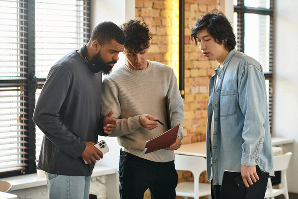 Colleagues collaborate in a contemporary workspace, reviewing project notes and sharing ideas.