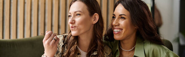 Two women enjoy each others company at a cozy cafe, sharing smiles and laughter over dessert.