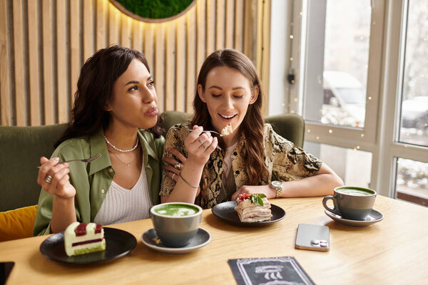 Two women celebrate their connection while enjoying desserts and drinks in a charming cafe