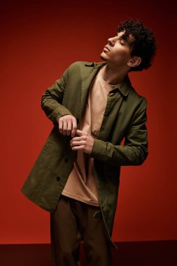 Genç, yakışıklı bir adam şık bir kıyafetle şık bir poz verirken moda anlayışını sergiliyor..