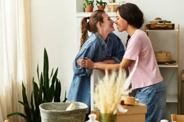 İki kadın şık evlerinde birbirlerine sevgi ve neşe saçarak kucaklaşırlar..