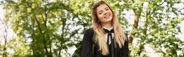 A cheerful young student in a fashionable uniform walks through a vibrant college campus, banner