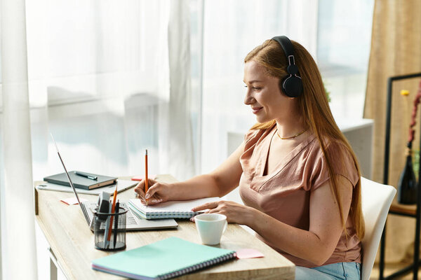A young woman enjoying her study time at home, surrounded by cozy decor and sunlight.