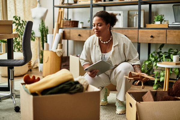 A beautiful woman kneels to organize craft materials in a vibrant and inspiring workshop.