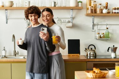 Mutlu bir çift, kahvaltı ve içeceklerle çevrili şık mutfaklarında vakit geçirmek ister..