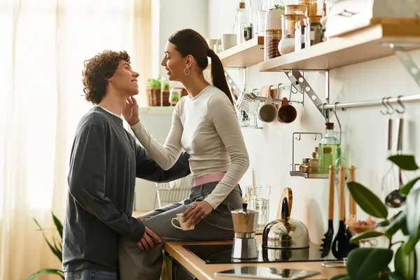Bir erkek ve bir kadın sıcaklıkla dolu parlak bir mutfakta otururken sevgilerini ifade ederler..