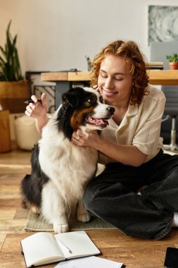 Genç bir adam evinde dinlenirken köpeğiyle güzel vakit geçirmekten zevk alır, gülümseme ve sıcaklığı paylaşır..