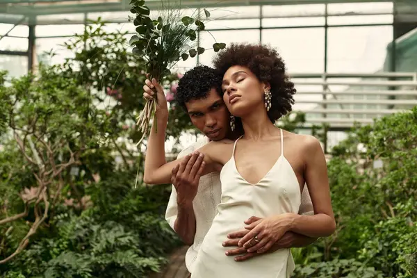 Serada, genç bir çift gelişen yeşillikler arasında sevgi dolu bir anı paylaşıyor..