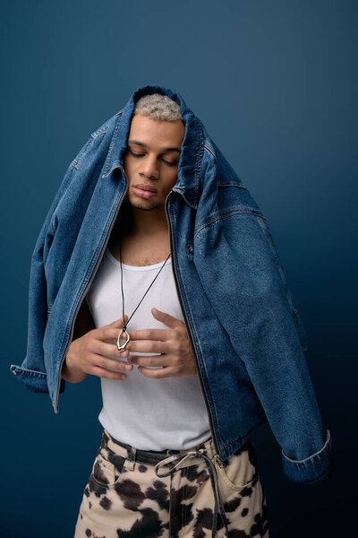 A young african american man displays a trendy outfit, emphasizing fashion and individuality.