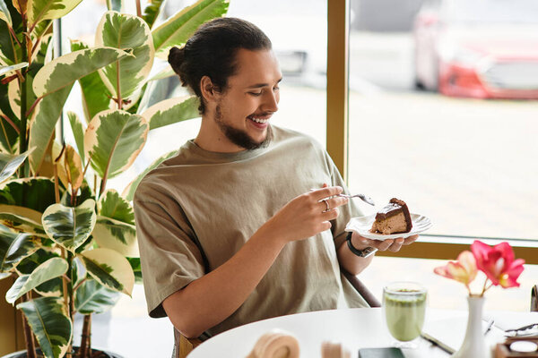 A young man with a beard savors a piece of cake
