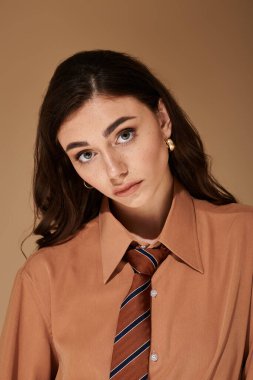 Sofistike bir stüdyoda, genç bir kadın şık kıyafetini özgüvenle sergiliyor..