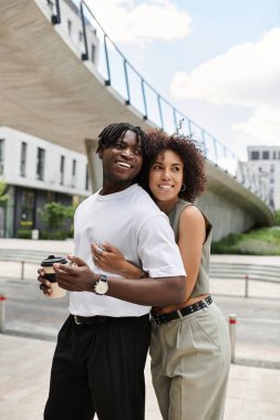 Şık genç çift, bir şehir ortamını keşfederken birbirlerinin yanında eğleniyorlar..