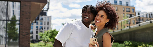 A stylish young couple enjoys a fun date in the city, surrounded by beautiful urban scenery, banner