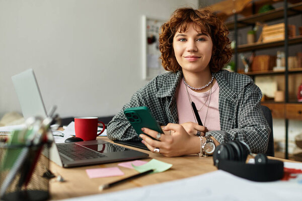 Молодая женщина с вьющимися волосами фокусируется на своем смартфоне, работая из дома в стильной квартире.