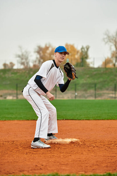 Talented teenager prepares for a pitch on a vibrant baseball field during a bright day.